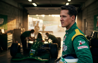 Young Michael Schumacher in Jordan F1 racing suit standing in garage next to Jordan 191 car at Spa-Francorchamps during his 1991 debut weekend