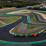 Aerial view of Istanbul Park circuit with F1 cars racing through Turn 8 at sunset