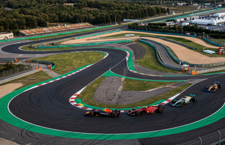 Aerial view of Istanbul Park circuit with F1 cars racing through Turn 8 at sunset