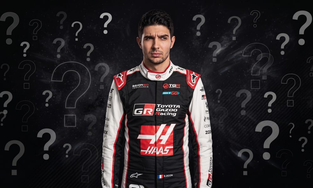 A serious-faced race car driver named E. Ocon, in his official Toyota Gazoo Racing and HAAS suit, stands against a dark background with numerous floating question marks.